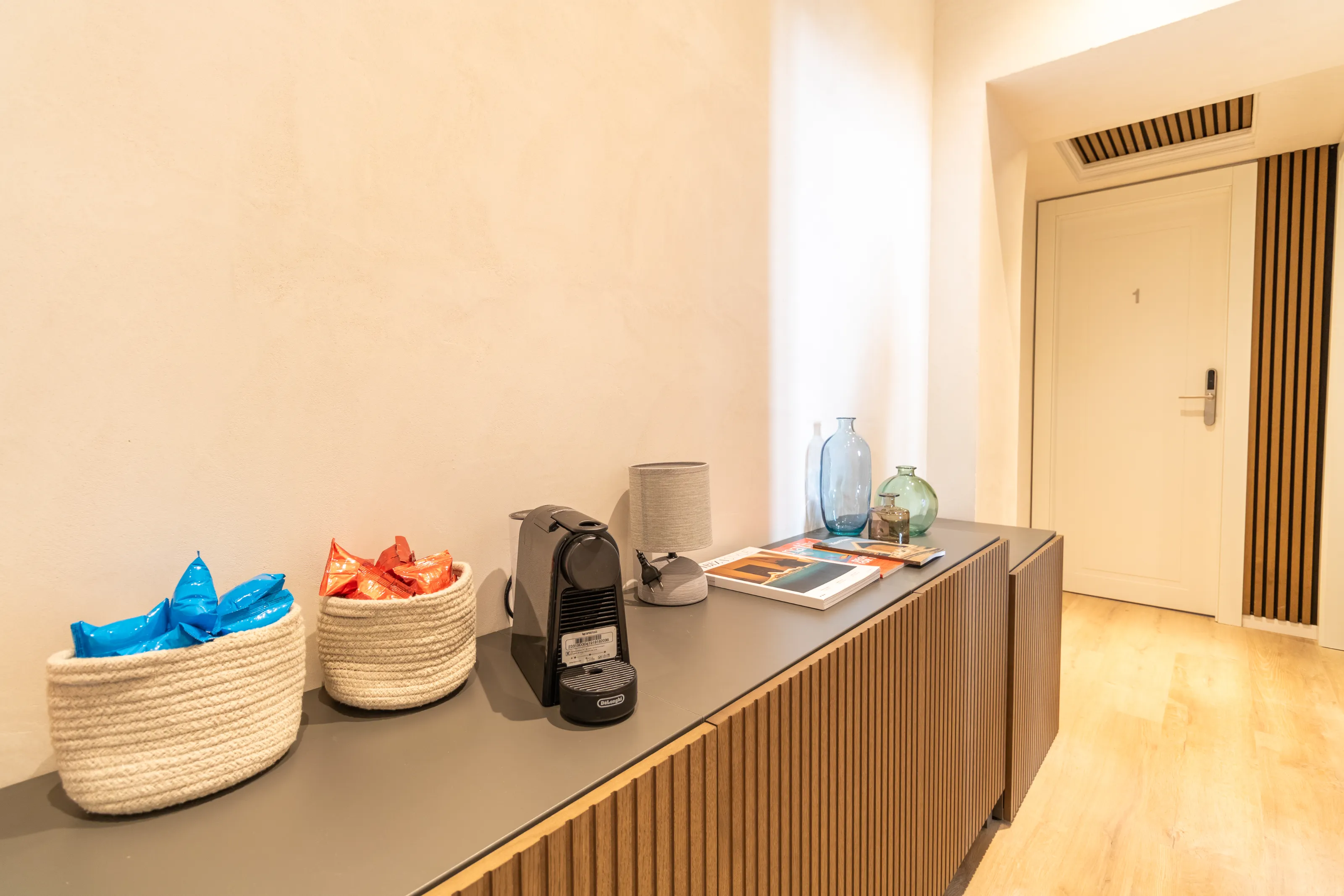 Complimentary coffee corner with snacks and a Nespresso machine