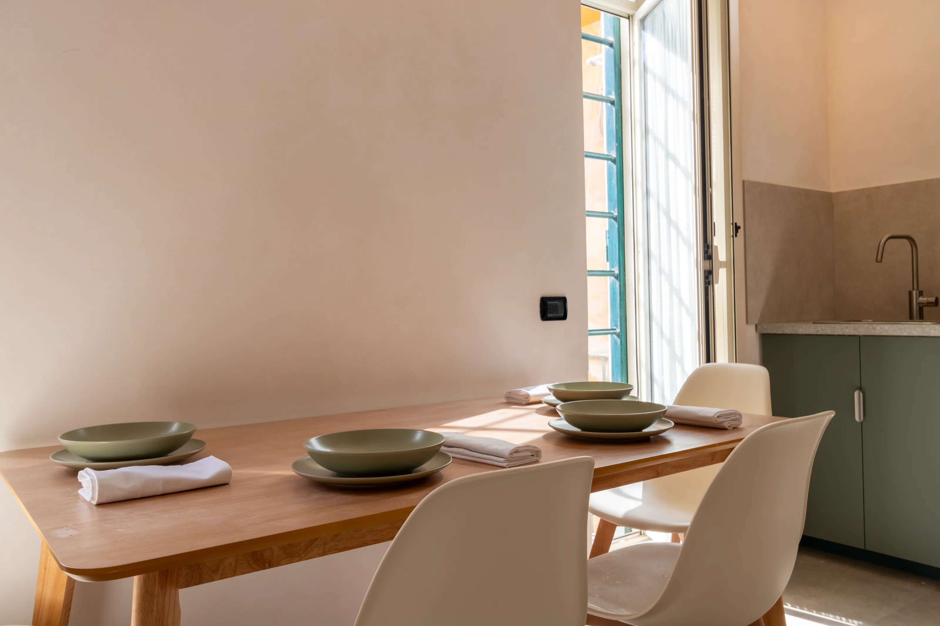 Dining table set for four with natural light